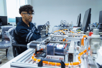 Technician working with robotics components