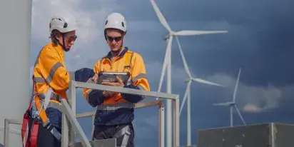 Mainteance team inspecting wind turbine